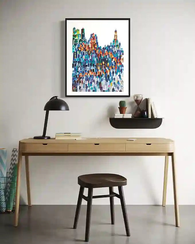 Modern home office with a wooden desk, lamp, and colorful abstract art print on the wall. by Sudanese Artist Yousif Ibrahim