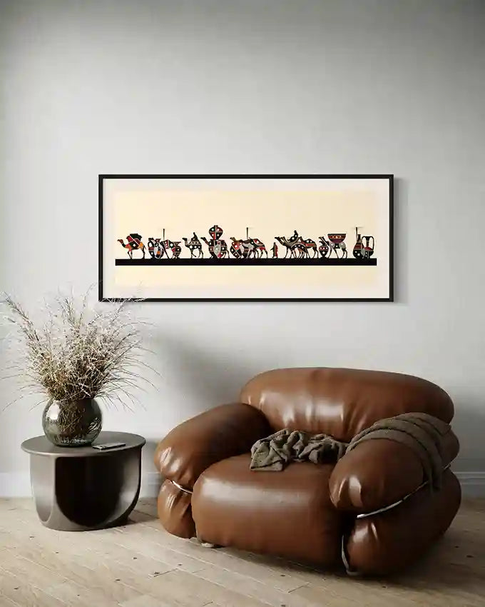 Brown leather armchair in a room with a framed art print of caravan by Artist Yousif Ibrahim on the wall. in UAE