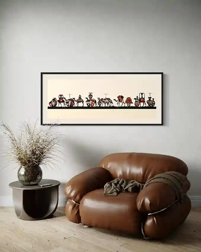 series of stylized camel figures in various poses, resembling a caravan. framed on a white wall with brown sofa, side table