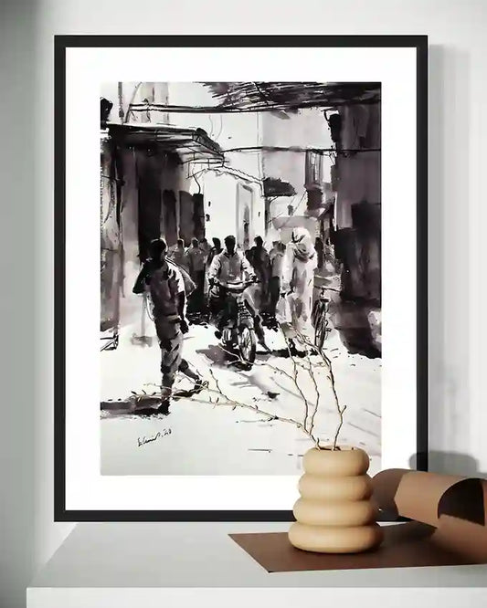 Framed "Echoes of the Souk" ink artwork by Elamin Awad on white wall with wooden stacked bowls on shelf below.