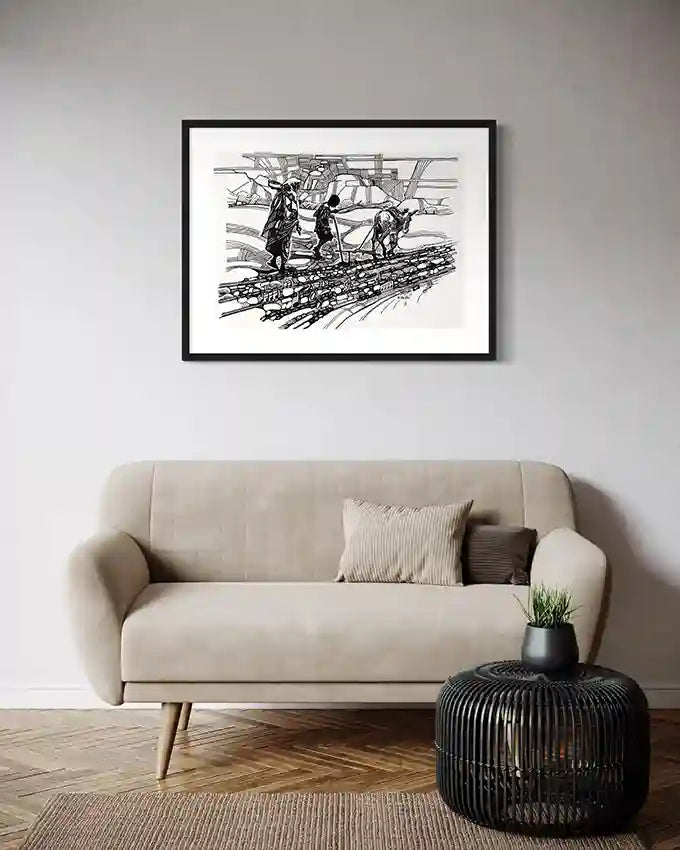 Black and white framed art print "Ground Notes" by Obada Gabir displayed above beige sofa in modern living room interior