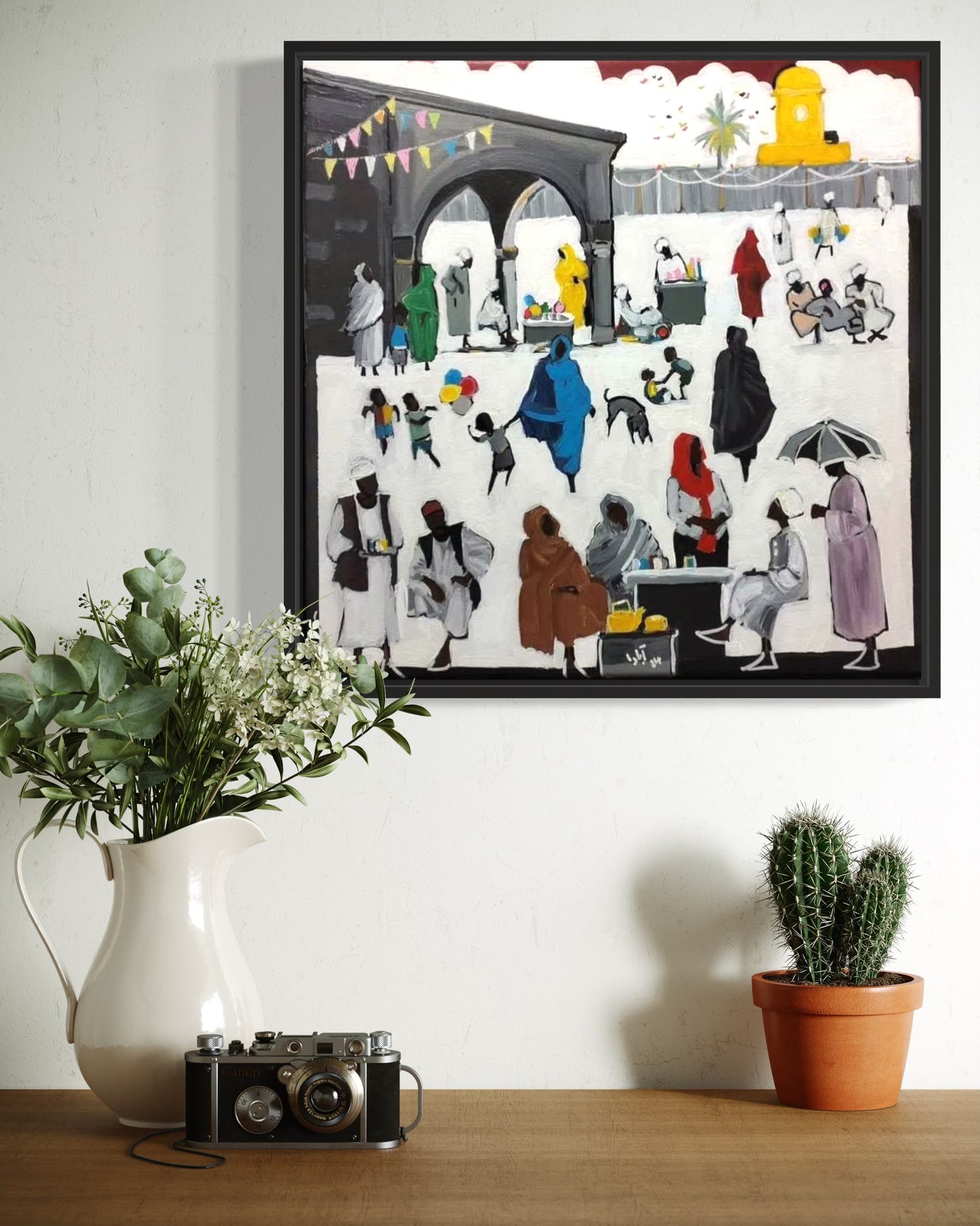 A vibrant acrylic painting on canvas depicting a market scene with various figures engaging in market activities, such as selling, buying, and walking. The artwork includes a range of colors, with clothing and accessories providing a vivid palette, and is signed on the lower right.