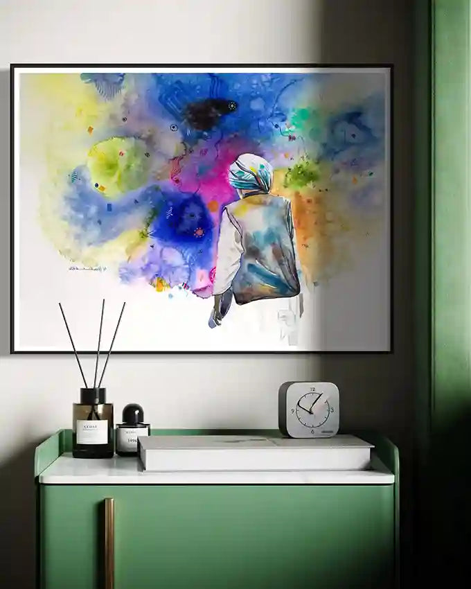 Framed print by Sudanese artist Galal Yousif art on a wall above a green console table with decorative items. UAE