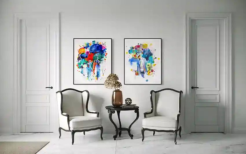 Two ornate chairs and a table in a white room with tow art prints by Sudanese artist Galal Yousif available in UAE