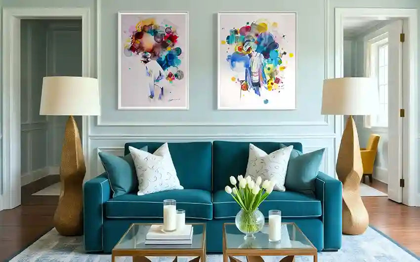 Modern living room with teal sofa, and decorative items. two colorful art prints of Galal Yousif framed on the wall