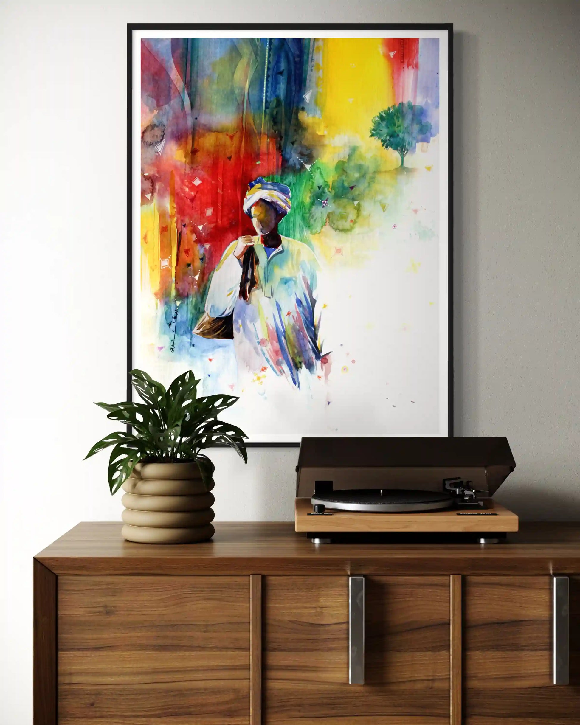 framed art print of Sudanese man on a wall above a wooden cabinet with a plant and record player. by artist Galal Yousif