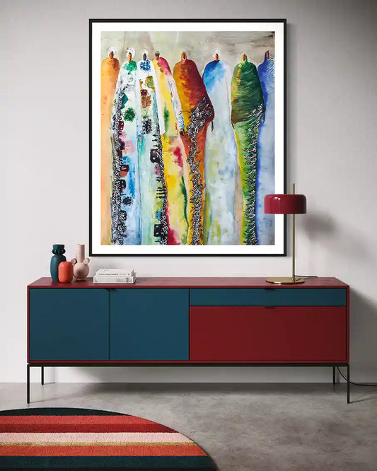Colorful abstract painting on a wall above a red and blue cabinet.