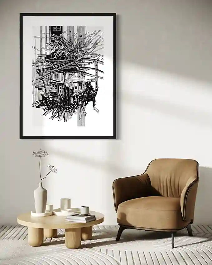 Urban tea vendor line art print by Obada Gabir in black frame above tan leather chair in minimalist living room