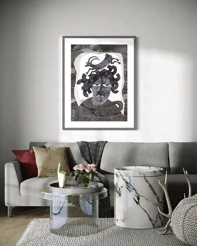 "The Storyteller" art print displayed above modern gray sofa with colorful pillows and marble coffee table.