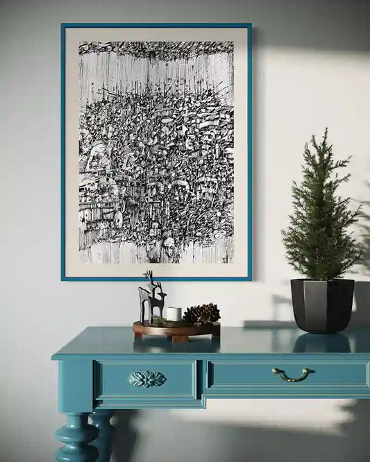The Weight of Rain" by Osman Gouma - black and white tree art print in blue frame above turquoise console with decor