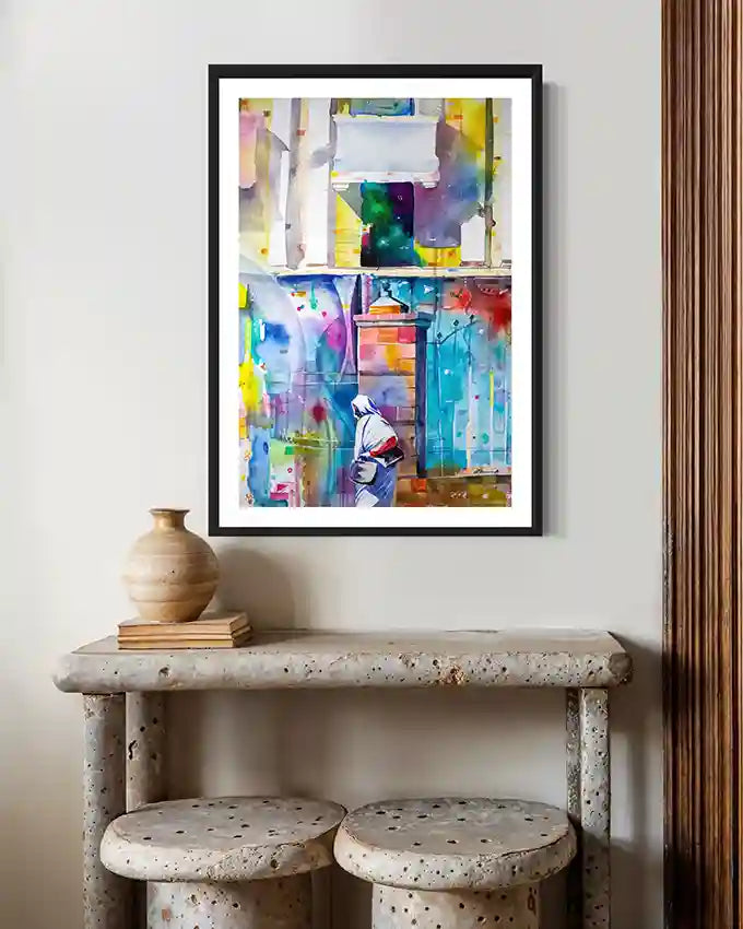 Colorful  framed abstract print of A Sudanese woman on wall above stone shelf with decorative items.by Artist Galal Yousif