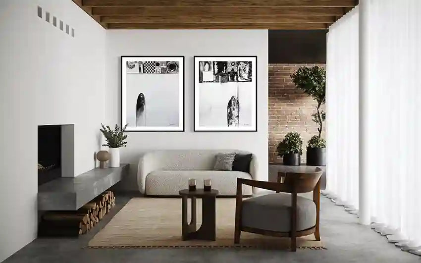 Art collection by Abushariaa Ahmed with two framed prints above off-white sofa in minimalist living room