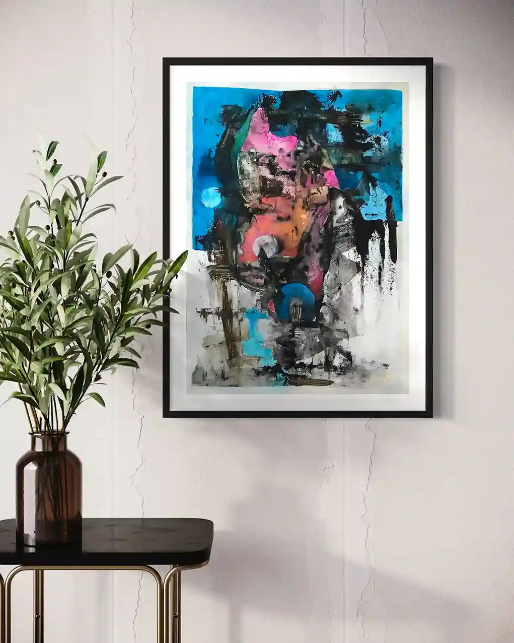 Blue Moon painting by Samir Shareef in black frame on white wall beside round table with plant in amber vase mockup