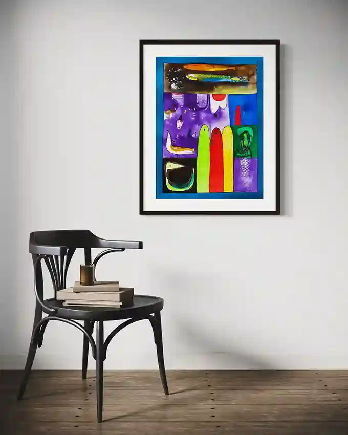 Fragmented Dreams colorful art print by Abushariaa Ahmed displayed in black frame above vintage chair in minimalist room