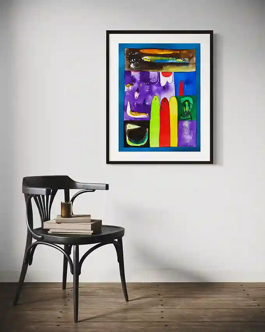 Fragmented Dreams colorful art print by Abushariaa Ahmed displayed in black frame above vintage chair in minimalist room