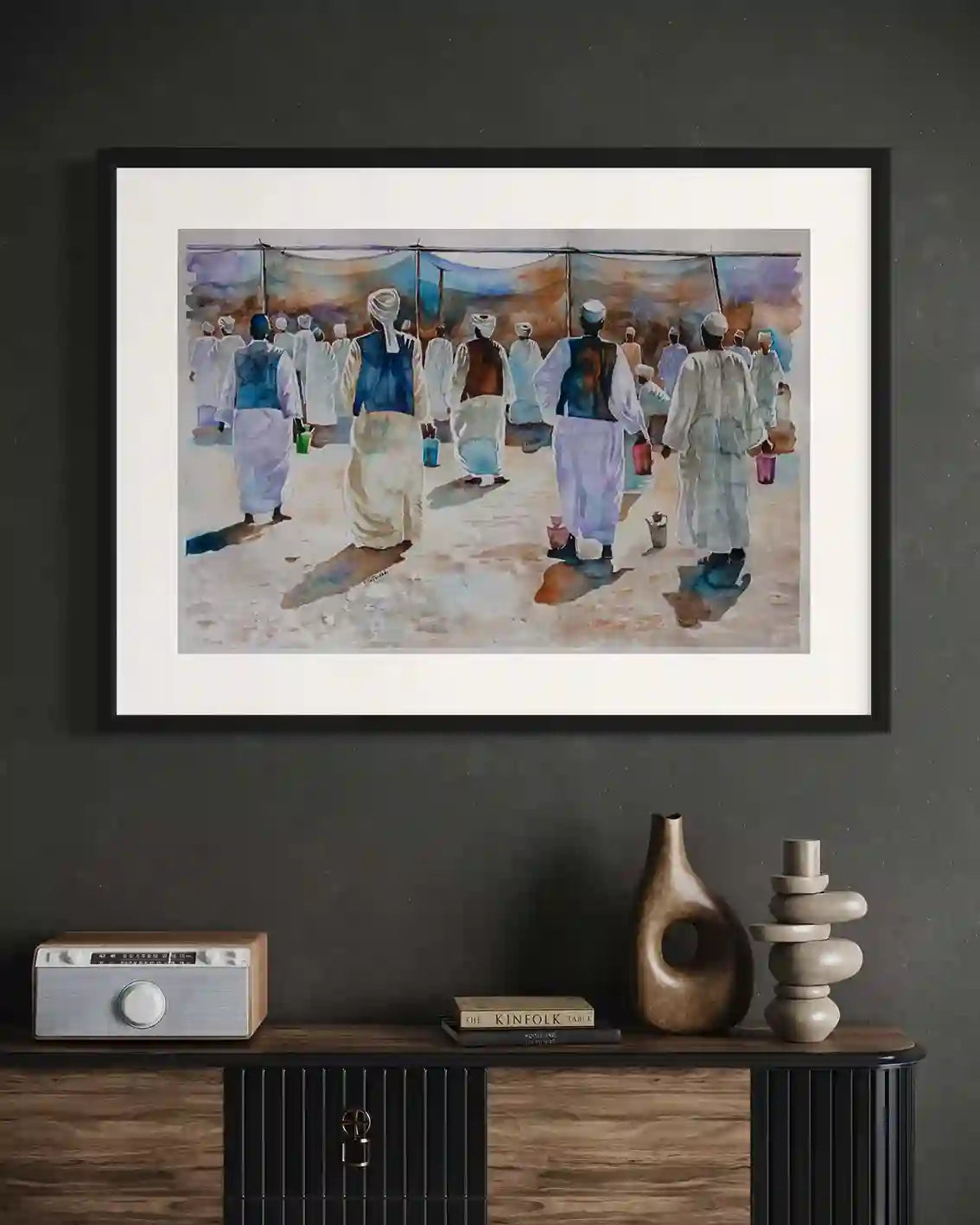 Harmony in White watercolor art print mockup by Salih Abdo showing framed Sudanese gathering scene in modern interior