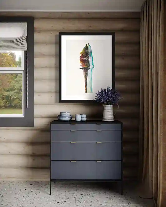 'just-married' art print of husband and wife by artist Yousif Ibrahim framed on a wall above a side table, in UAE