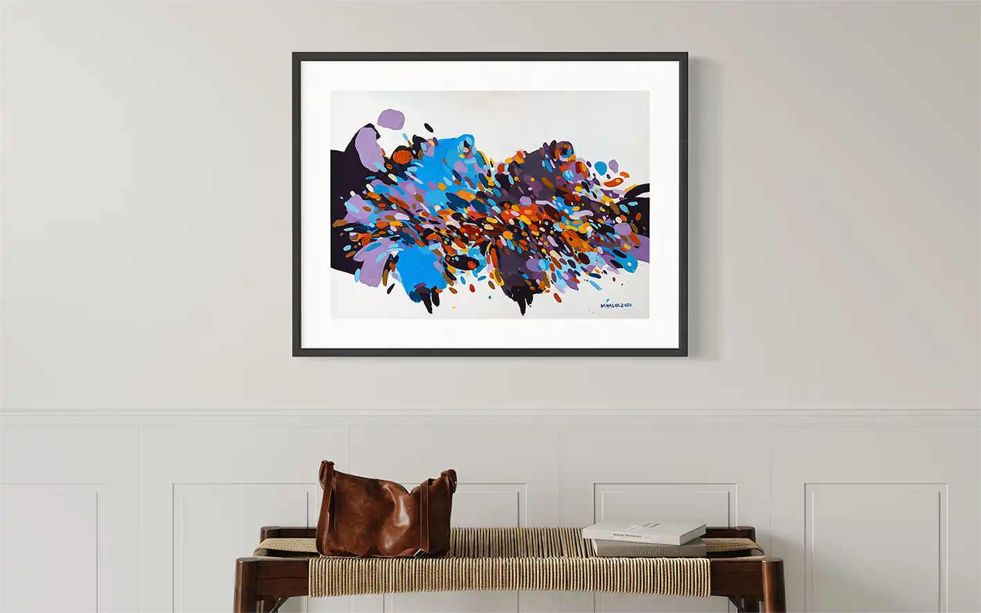 Sudanese Grace abstract art print by Khalid Yan displayed in black frame above wooden bench in elegant bedroom interior