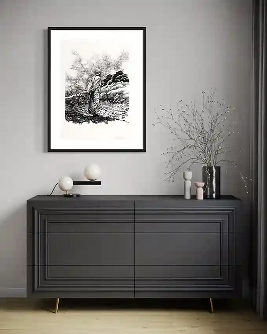Obada Gabir Contemplation pen and ink art print in black frame displayed above dark gray dresser with modern lamps