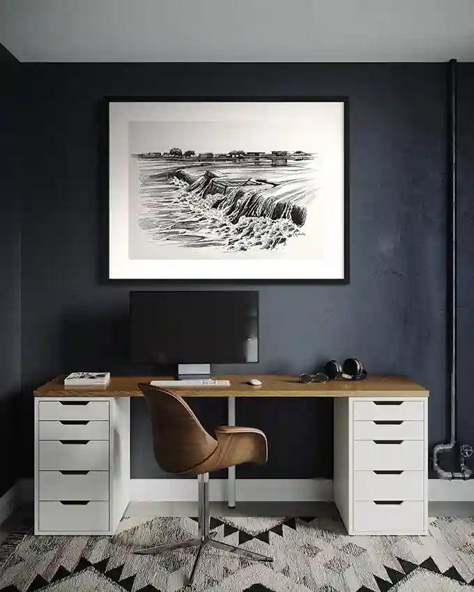 Obada Gabir waterfall pen and ink art print in white frame displayed above modern home office desk with dark blue wall and leather chair