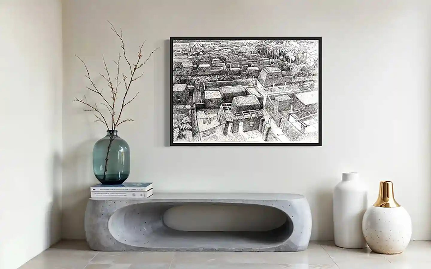 Tayba art print by Hatim Kuku in black frame above modern concrete console with blue glass vase and ceramic accessories