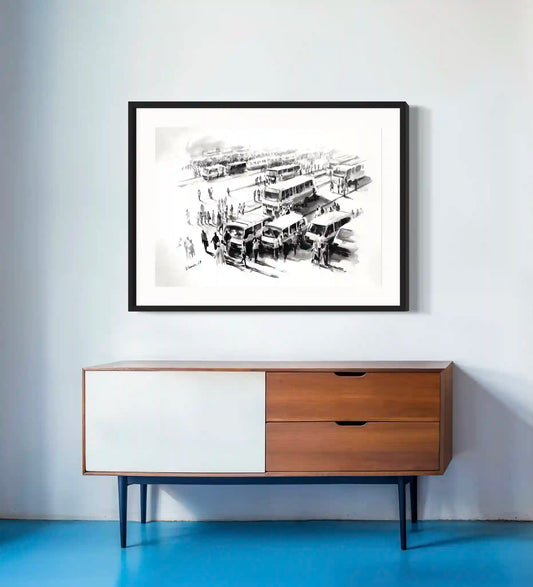 Framed black and white bus station artwork by Elamin Awad hanging above mid-century modern wooden credenza on blue floor