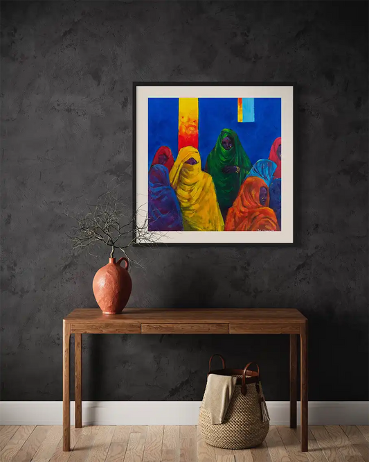 Veiled Voices by Mohamed Ohaj framed art print mockup on dark wall with wooden console table, pottery and woven basket decor