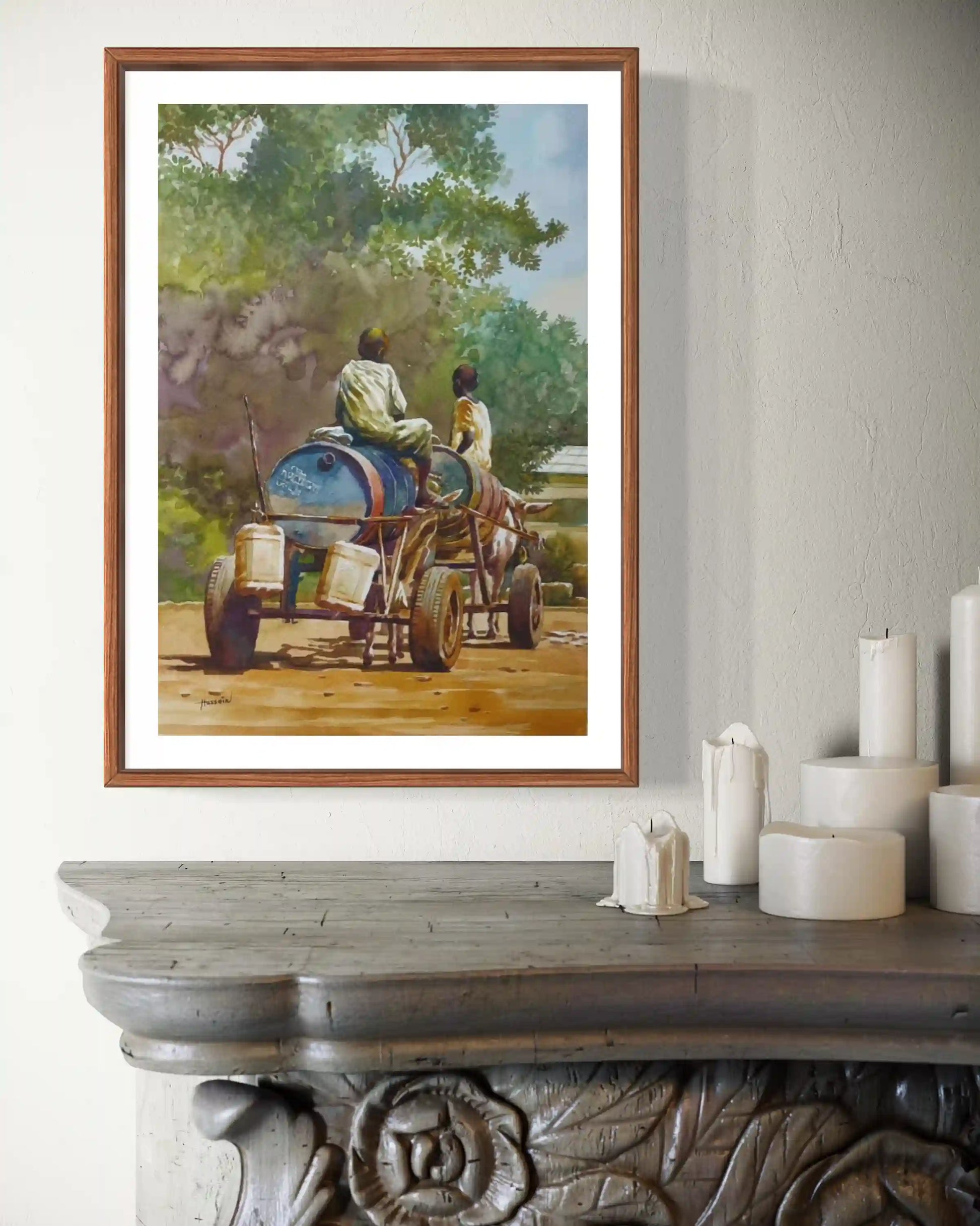 Water Cart by Hussein Merghani watercolor print in wooden frame on rustic console with candles home decor mockup display