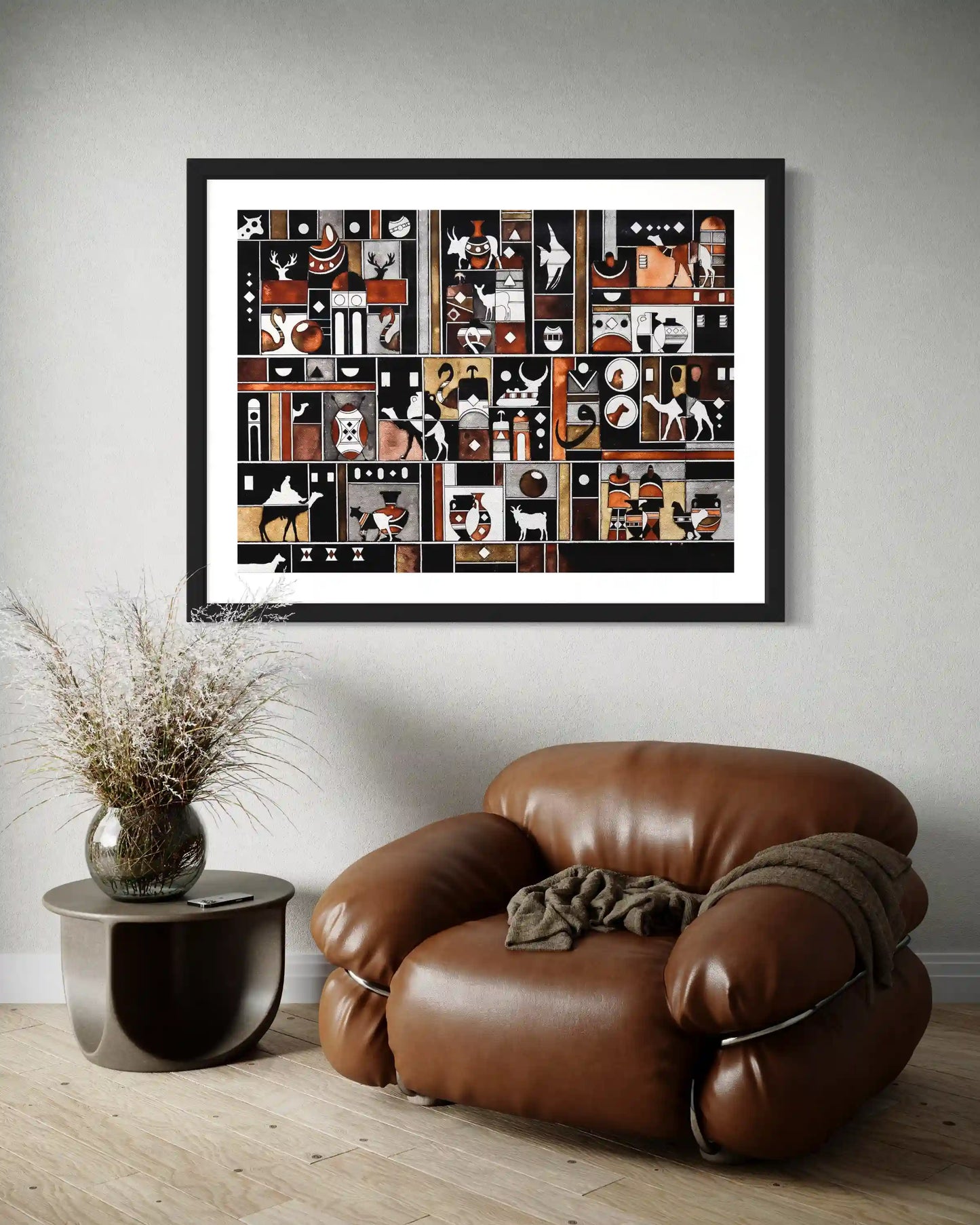 framed print 'glimpses' on wall, by artist Yousif Ibrahim in a room with leather armchair and table with flowers walls.