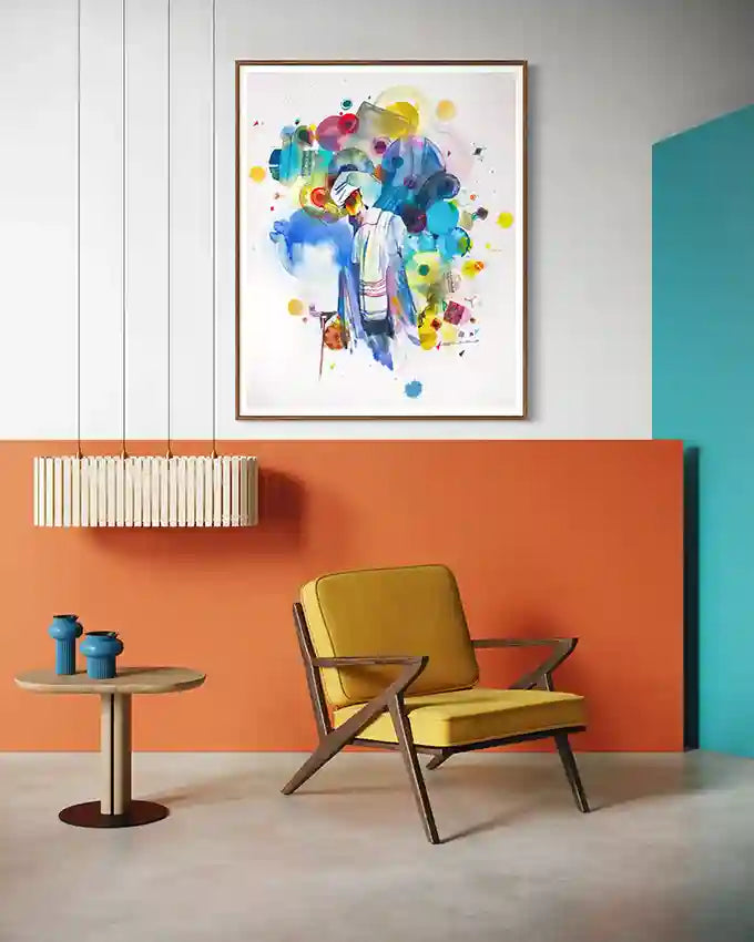 Modern living room with a yellow armchair, colorful art print by artist Galal Yousif and an orange accent wall.