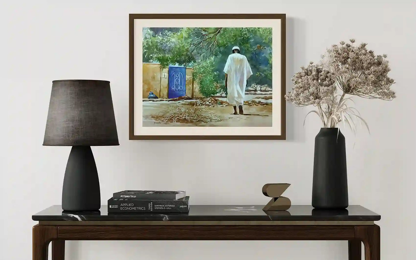 The Blue Door watercolor by Hussein Merghani displayed in wooden frame above modern console with minimalist decor styling