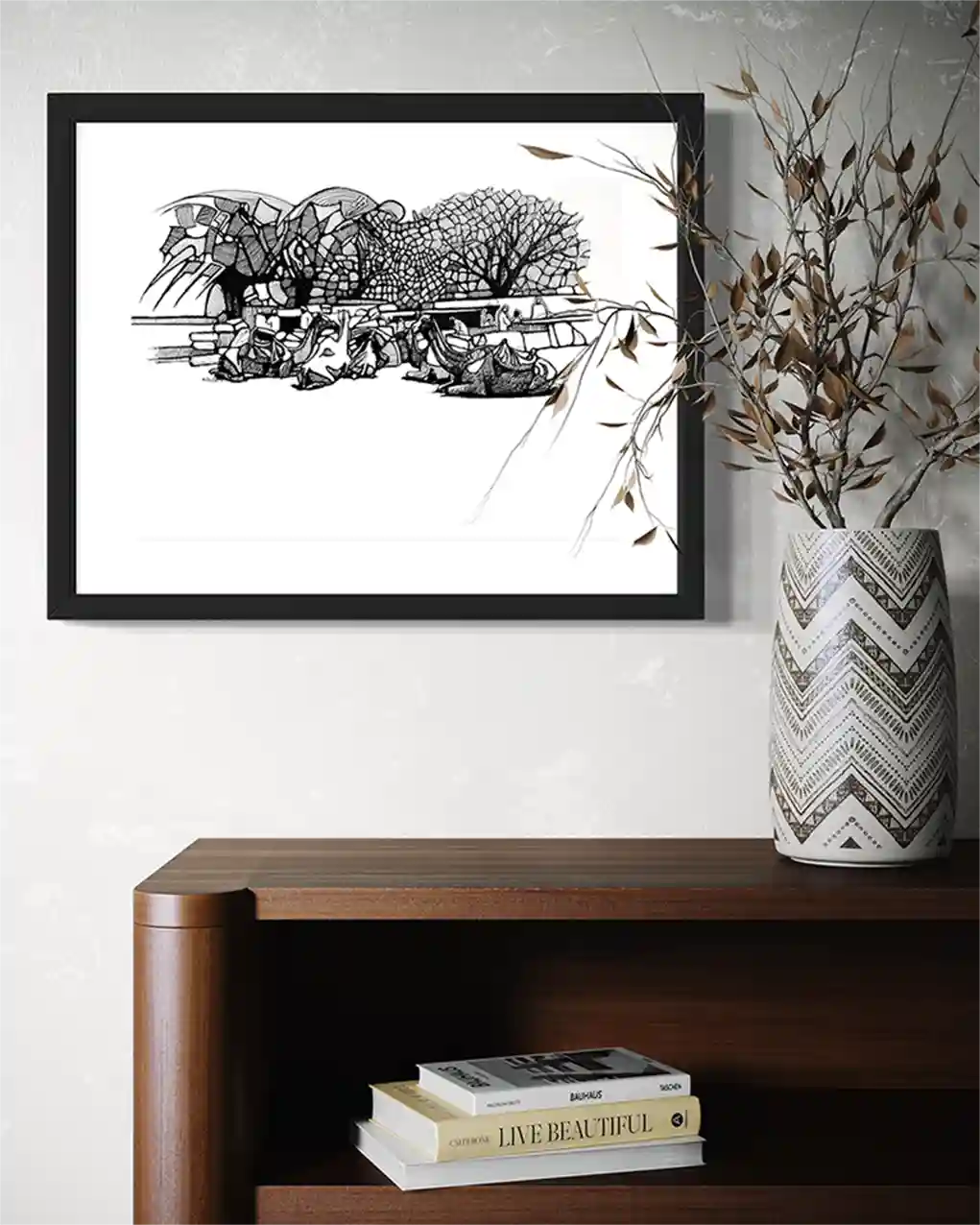 Camel Caravan framed ink painting by Obada Gabir displayed on wall above wooden console with vase and books home decor
