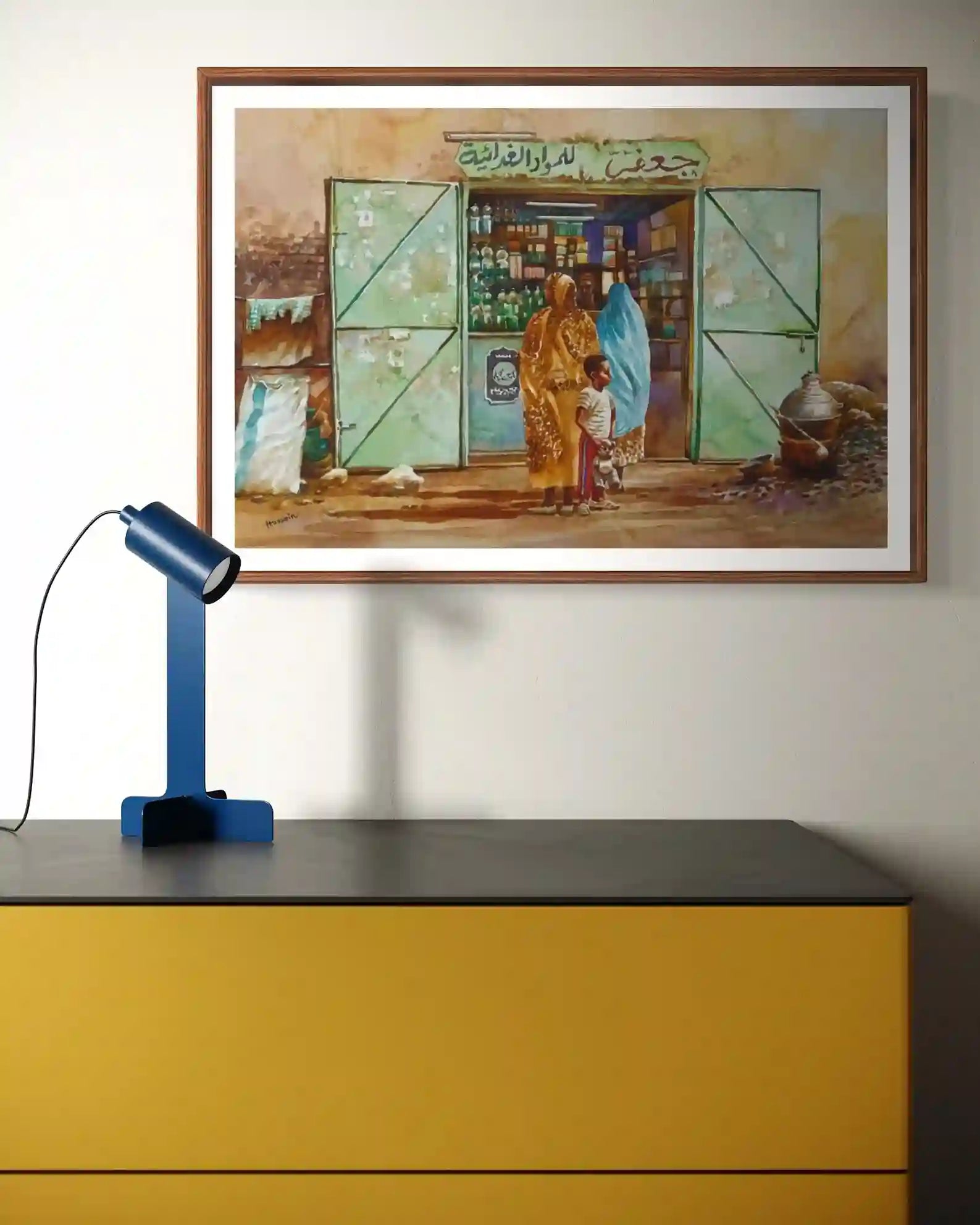 Dukkan Al-Hara original watercolor by Hussein Merghani 34x26cm framed mockup Sudanese corner shop painting