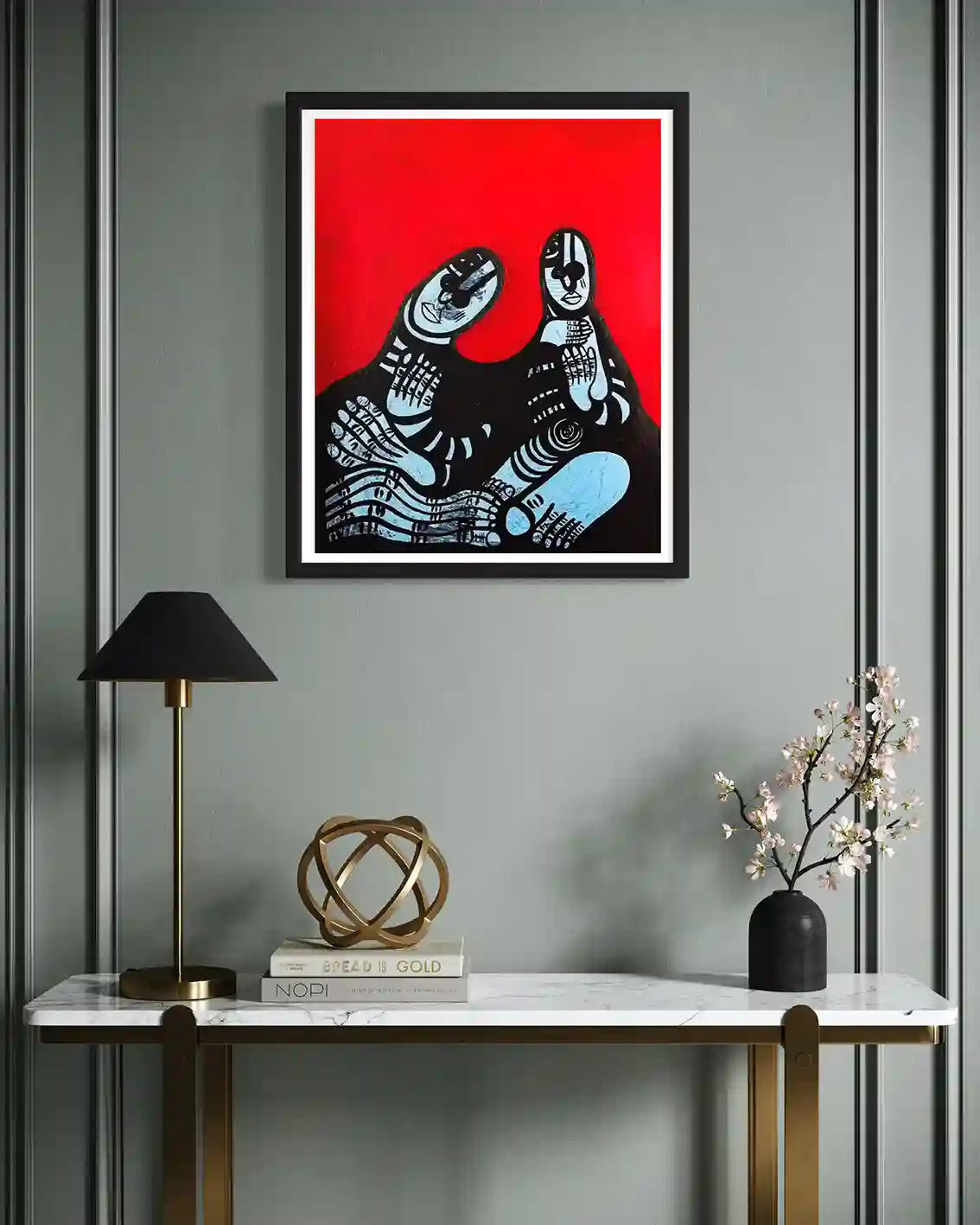 "Family Portrait" by Usra Hamza art print in black frame on gray paneled wall above marble console with lamp and decor