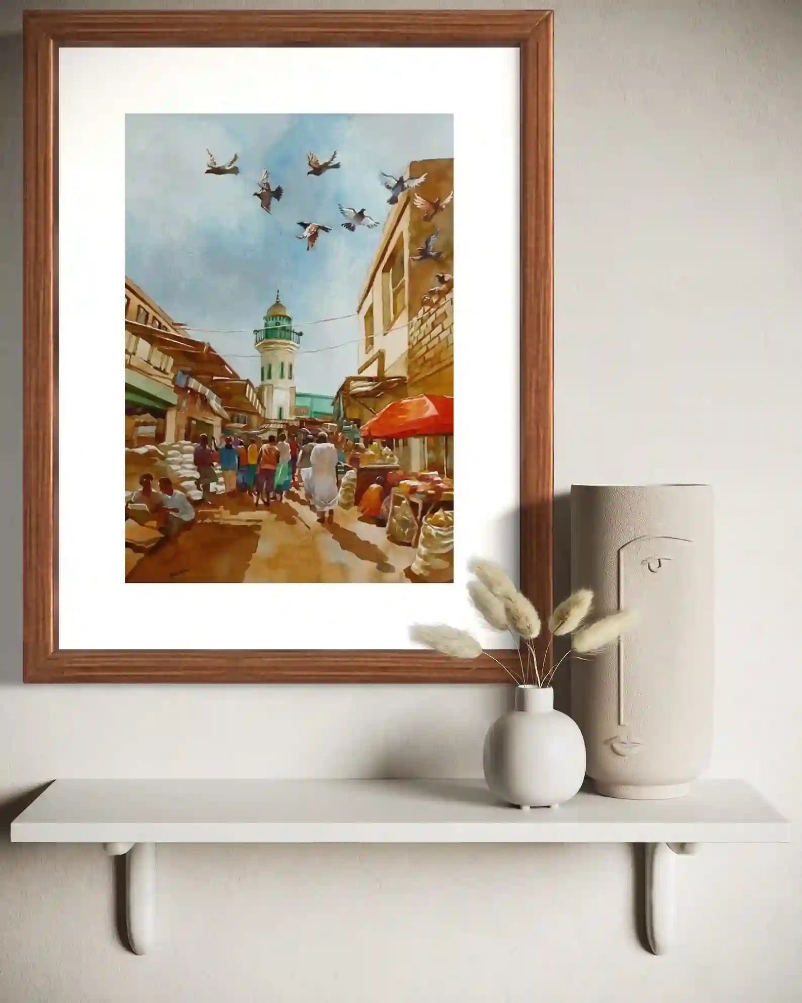 Minaret Market watercolor by Hussein Merghani framed mockup on shelf with vases home decor wall art display setup