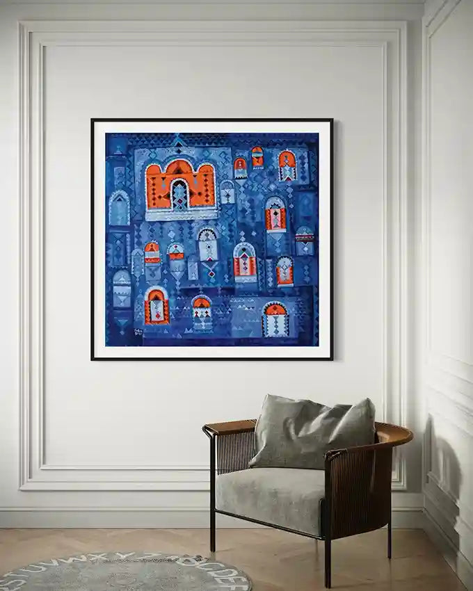 Framed Nubian doors artwork in blue and orange hanging on white wall above modern chair with gray cushion.