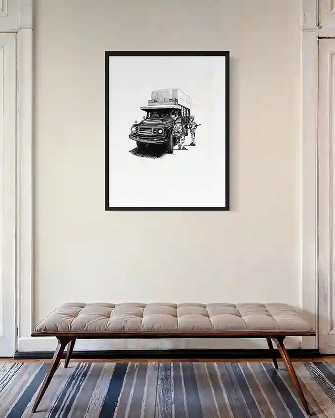 The Stop art print by Obada Gabir in black frame displayed above tufted leather bench in elegant hallway with white paneled walls and striped rug