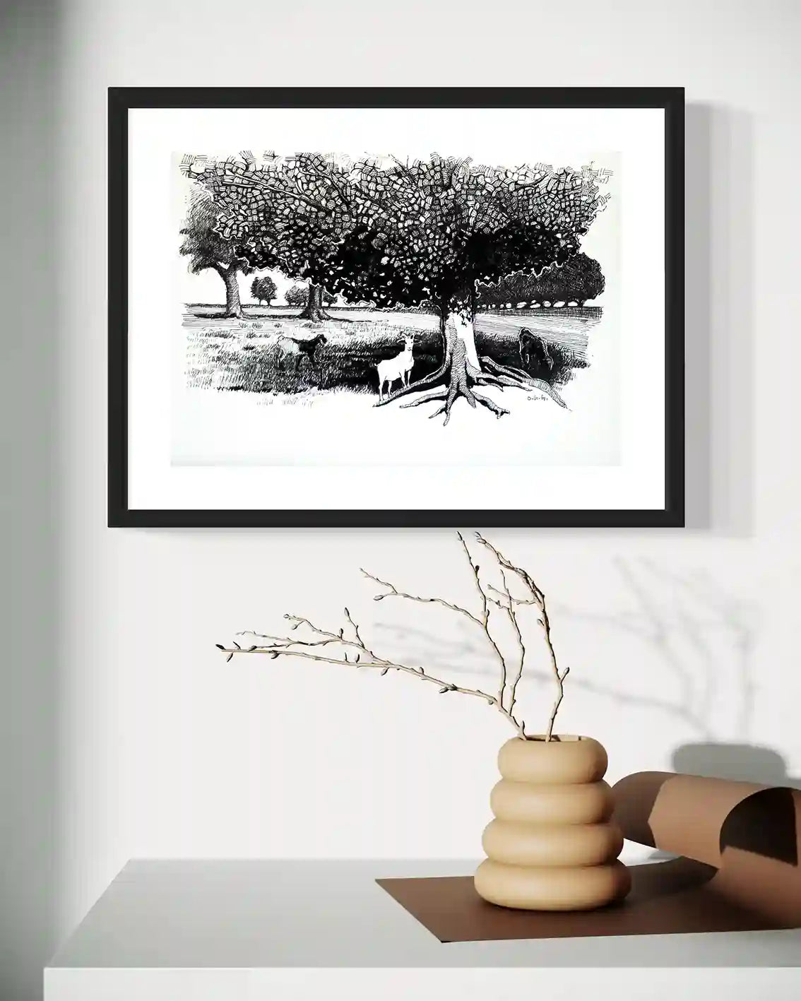 Pastoral Refuge framed ink painting by Obada Gabir displayed on wall above modern wooden shelf with decorative objects