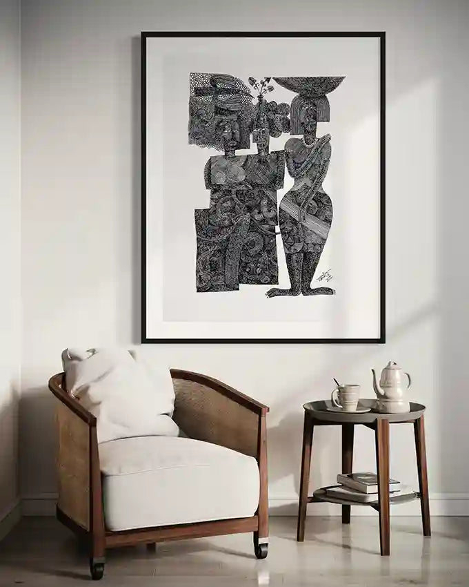 "Sisterhood" art print by Tariq Nasre displayed above wooden armchair with white cushions and round side table