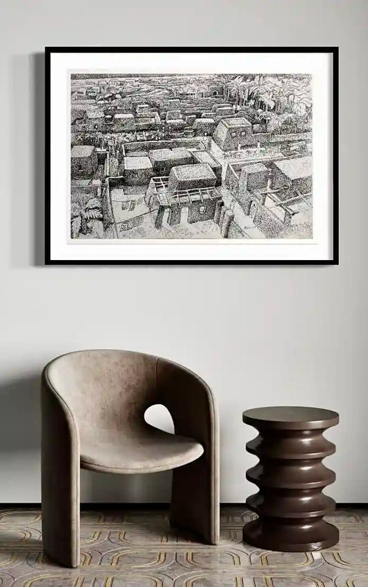 Tayba art print by Hatim Kuku in black frame displayed above modern beige chair and sculptural side table interior
