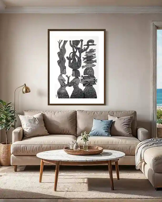 "The Tree Mothers" art print by Tariq Nasre displayed above beige sectional sofa with marble coffee table in living room