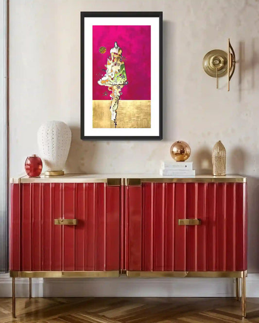Framed 'Untouchable' art print displayed above red fluted cabinet with gold accents and decorative objects in elegant room